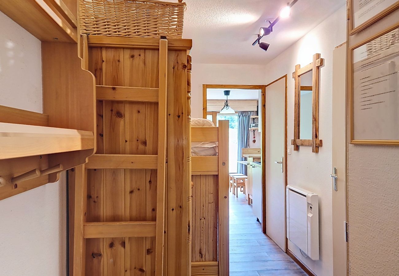Cozy hallway bedroom with bunk beds and natural wood details